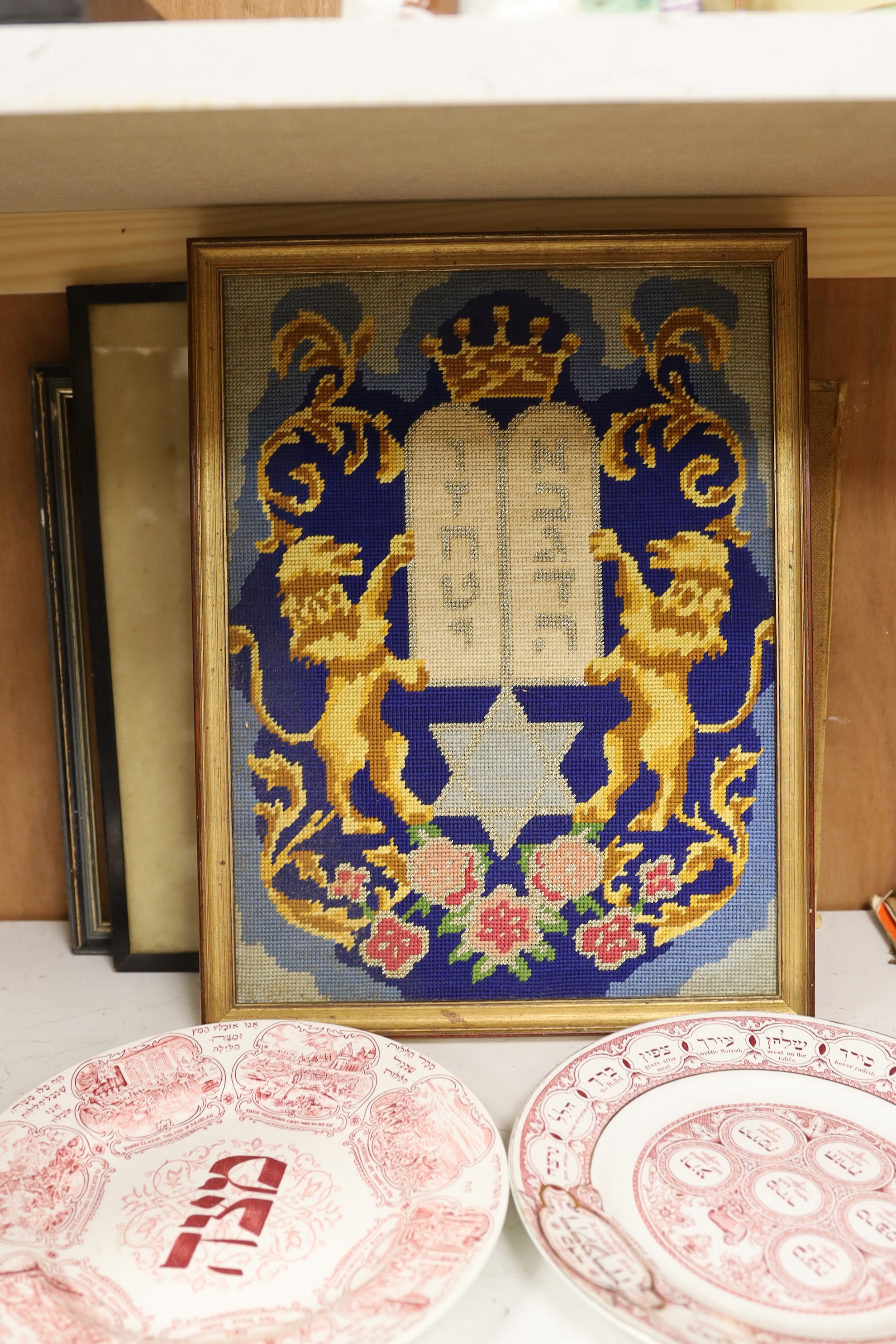 Judaica - two 1920's Ridgways pottery Passover plates, a needlepoint picture and two prints